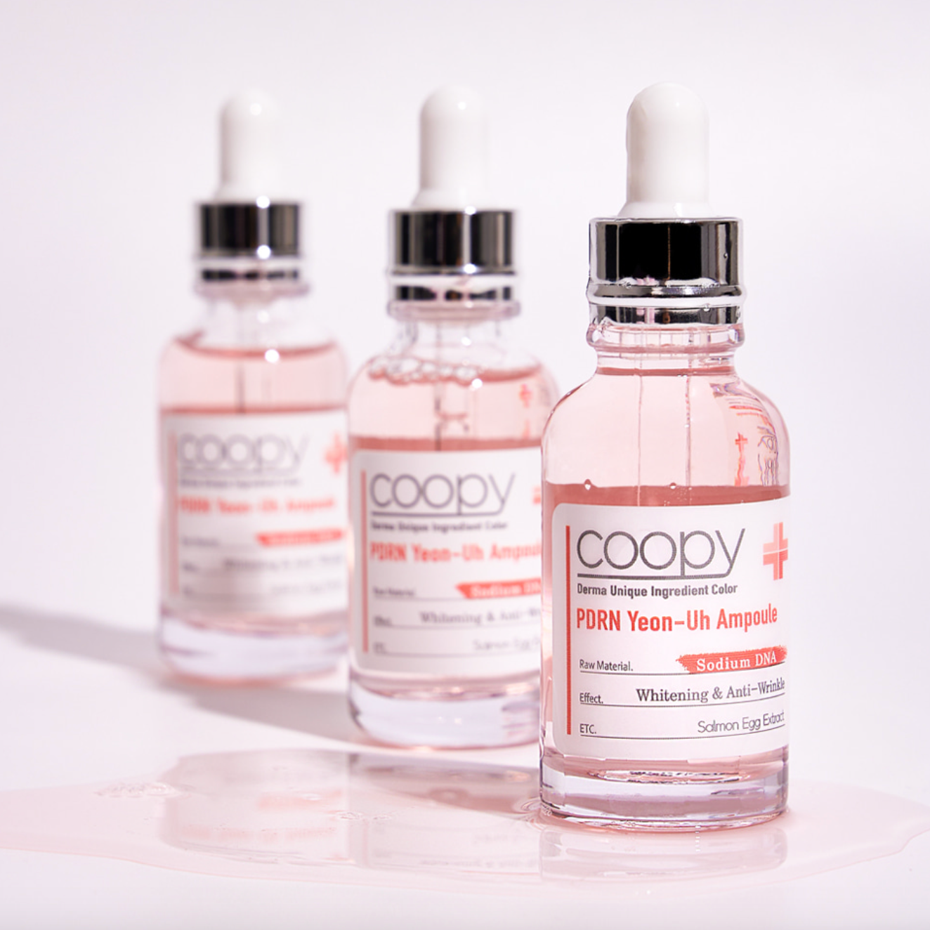 30ml COOPY PDRN Salmon Ampoule in a clear glass bottle with a pink label.