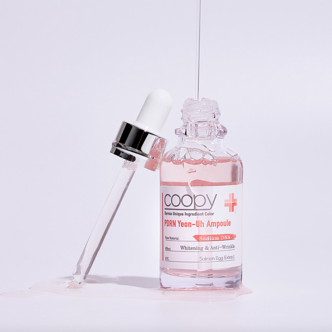 Clear glass bottle of COOPY PDRN Salmon Ampoule 30ml with pink label.