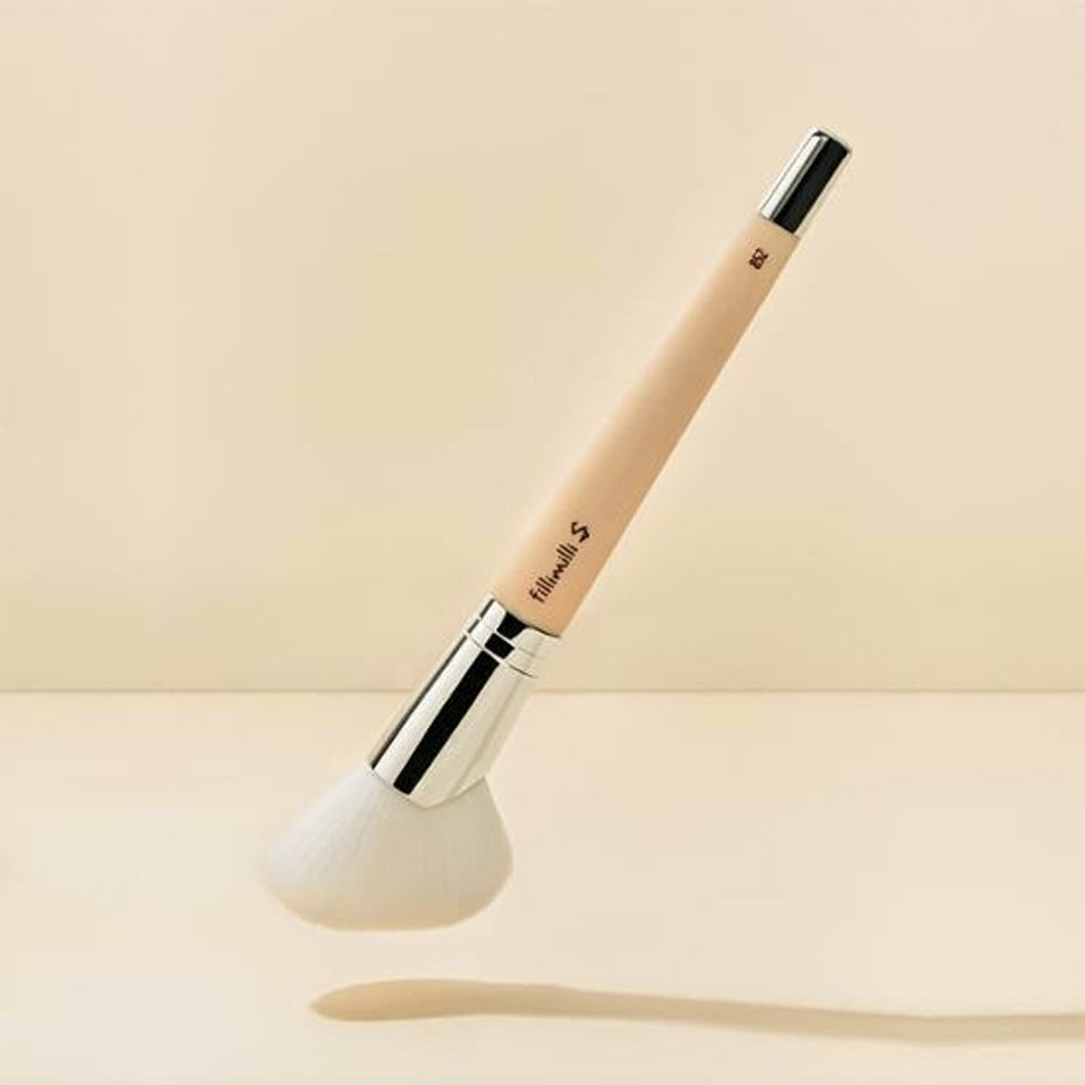It features a tapered, rounded brush head with soft, densely packed bristles that allow for accurate shading and definition.