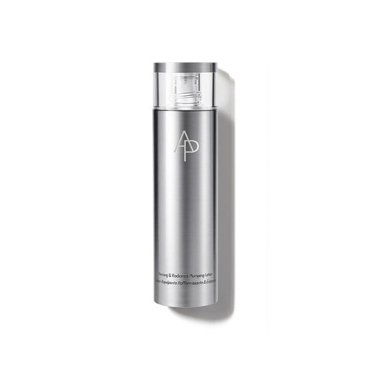 A bottle of AP M.D. Firming & Radiance Plumping Lotion 150ml on a white surface.
