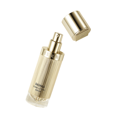 a bottle of perfume sitting next to a metal container